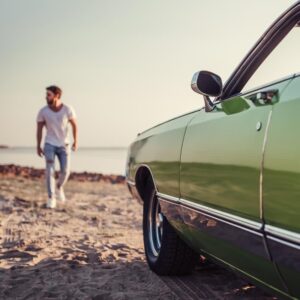 Man Walking to Car on Beach